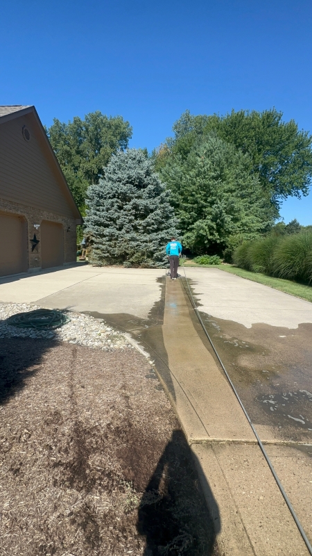 Salo’s Pressure Washing technician cleaning a concrete driveway in Dayton, Ohio